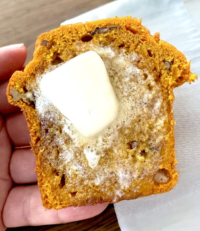 melted butter on slice of pumpkin bread.