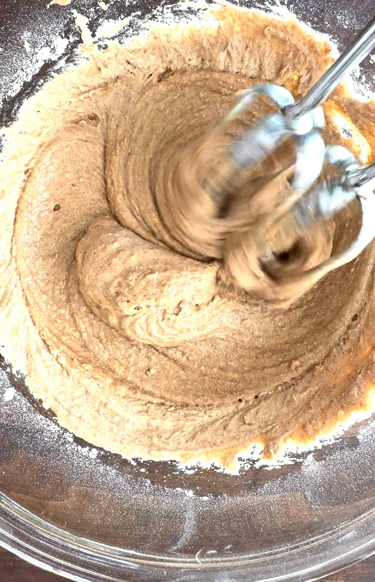 Cake batter being mixed with a hand mixer.