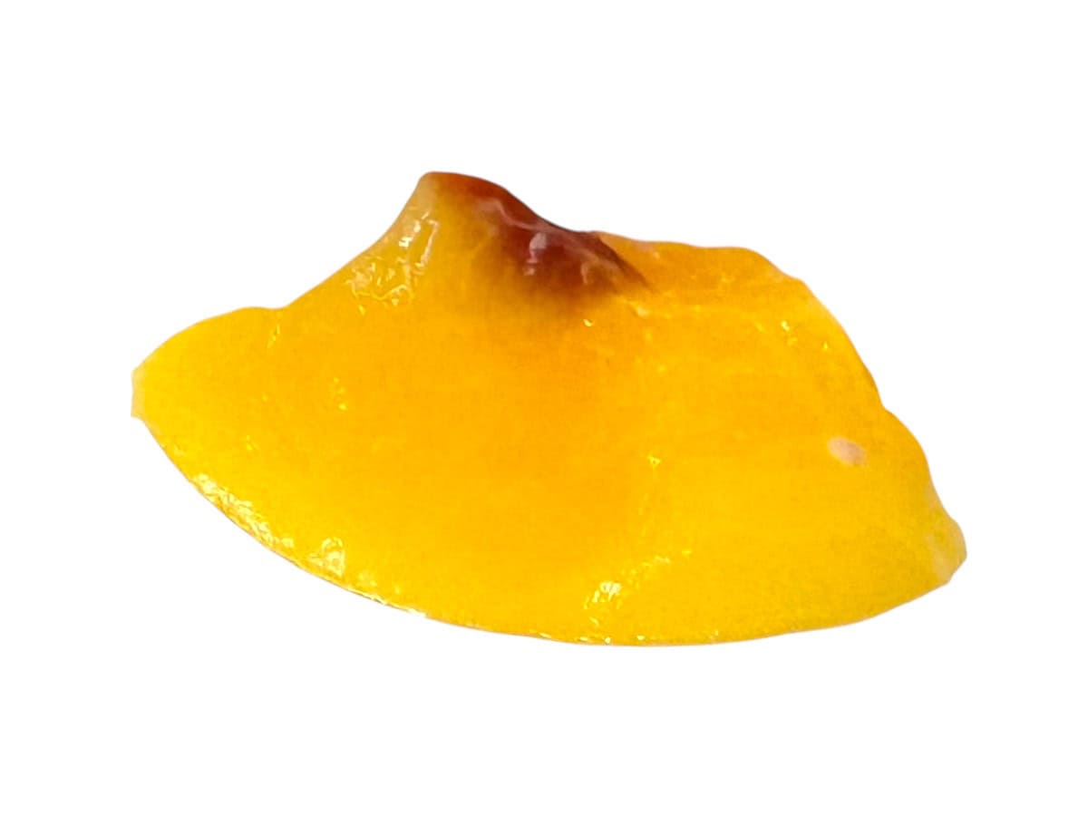 Peach with some pit attached.