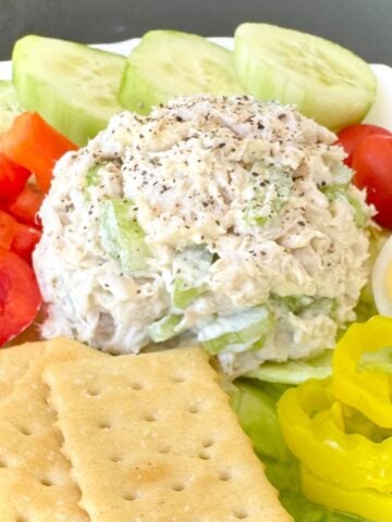 plate of chicken salad with fixings.