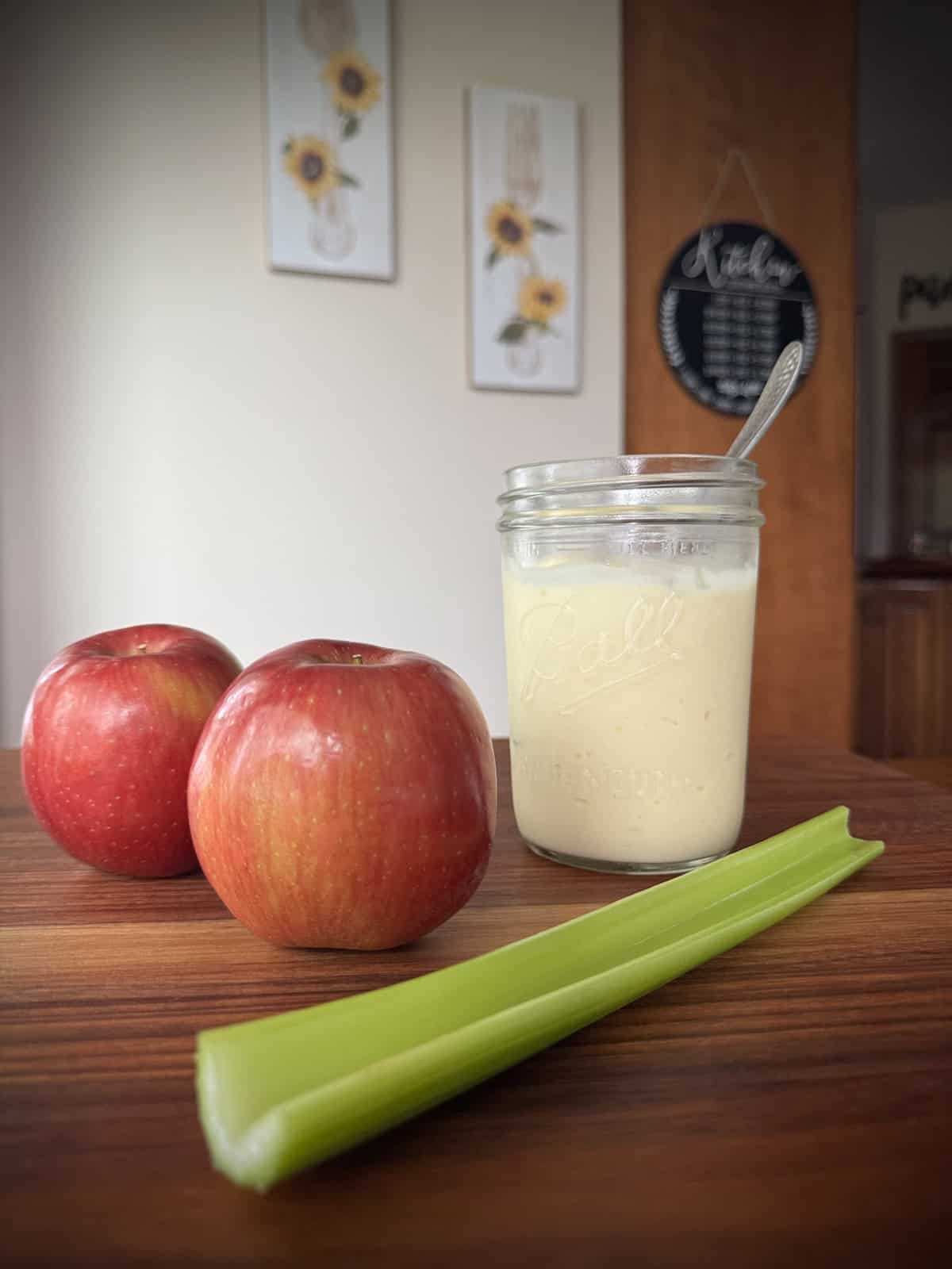 Ingredients for the original waldorf salad. Apples, celery and homemade jar of mayo.