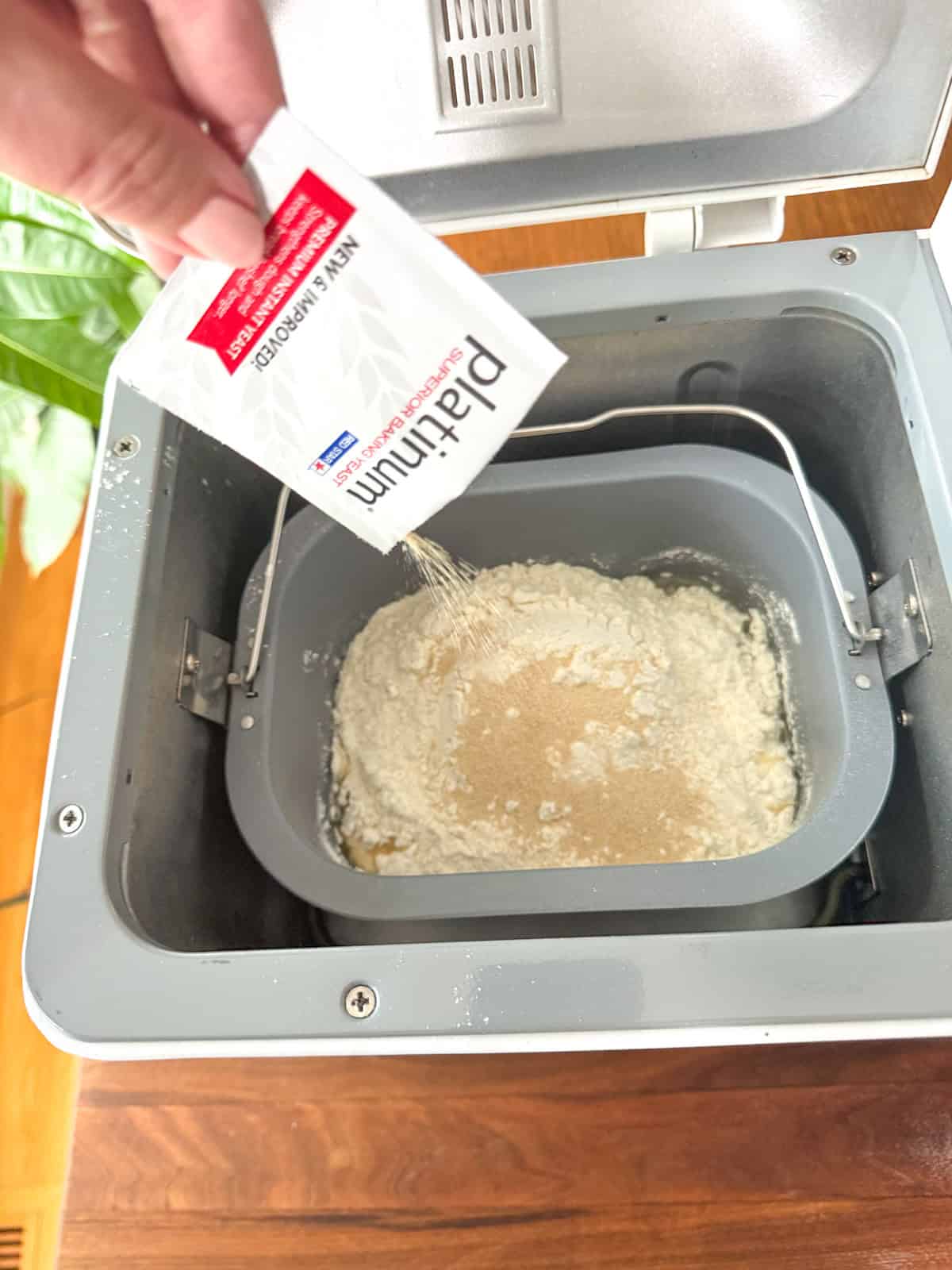 Adding yeast last to the bread machine.