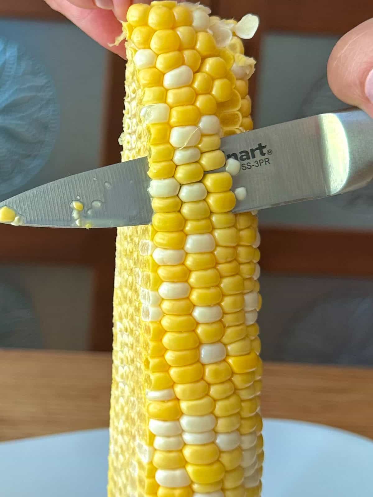 cut corn with a knife.