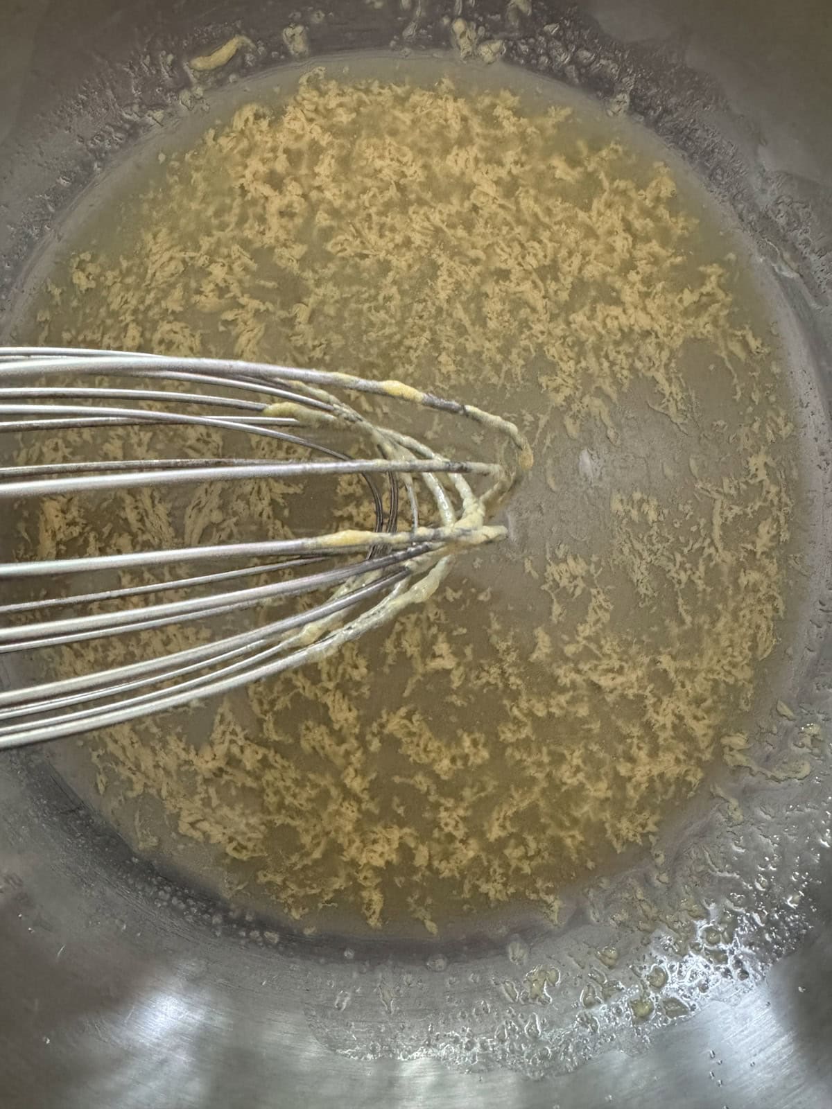 Whisking butter and mustard.